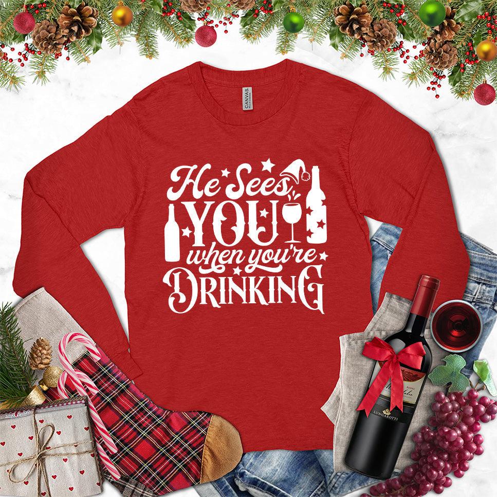 He Sees You When You're Drinking Long Sleeves Red - Humorous long sleeve holiday shirt with festive drinking phrase design