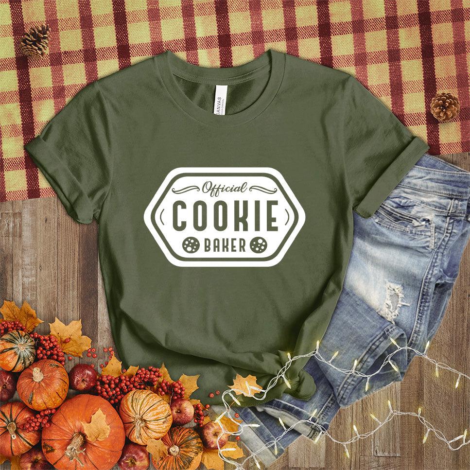 Official Cookie Baker T-Shirt Military Green - Graphic tee with 'Official Cookie Baker' logo in a festive kitchen setting