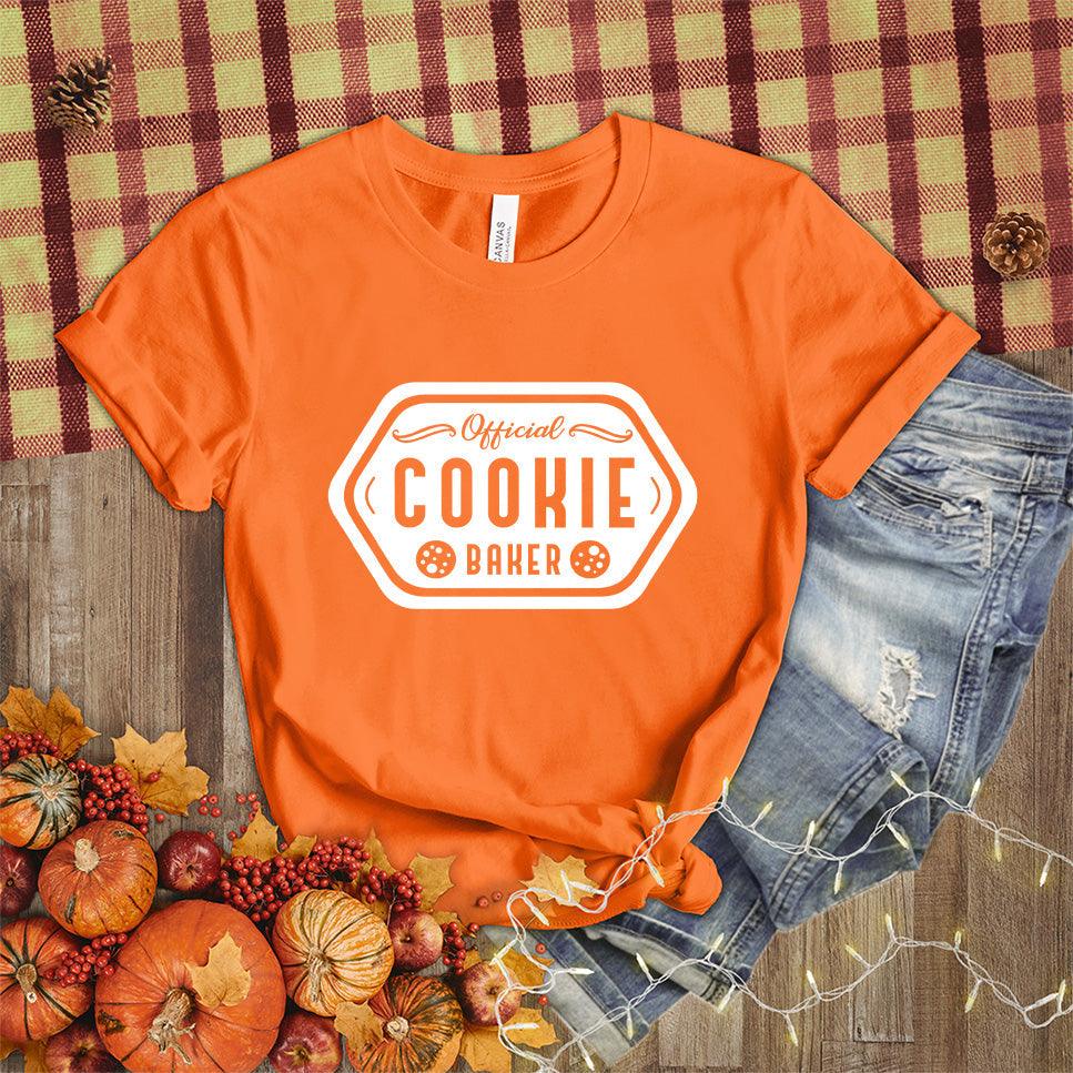 Official Cookie Baker T-Shirt Orange - Graphic tee with 'Official Cookie Baker' logo in a festive kitchen setting