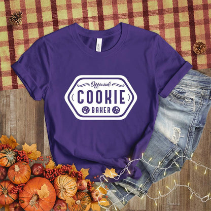 Official Cookie Baker T-Shirt Team Purple - Graphic tee with 'Official Cookie Baker' logo in a festive kitchen setting