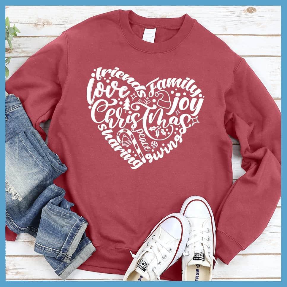 Christmas Heart Sweatshirt Crimson - Holiday-themed graphic sweatshirt with Christmas and joyful expressions in heart design.