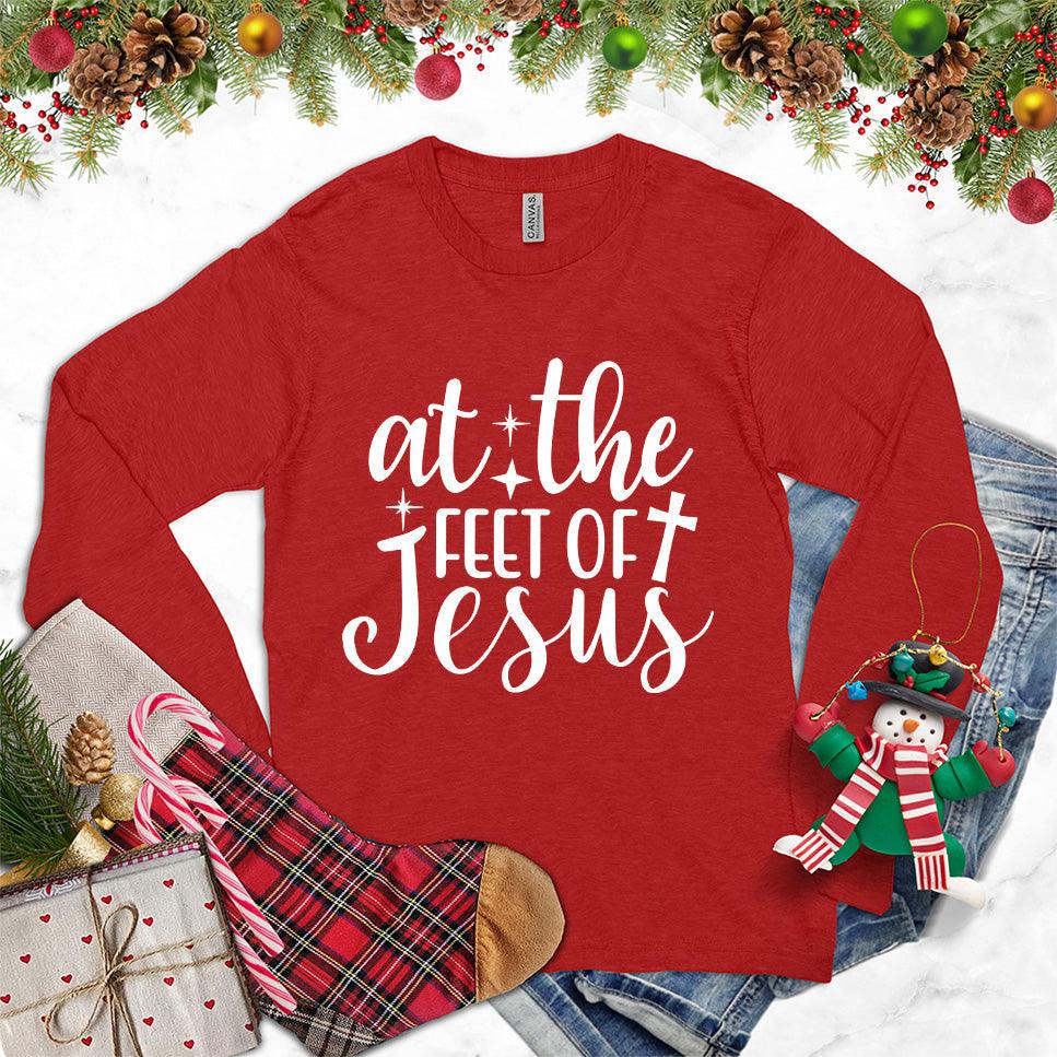 At The Feet Of Jesus Long Sleeves Red - Christian-themed long sleeve shirt with inspirational quote design.