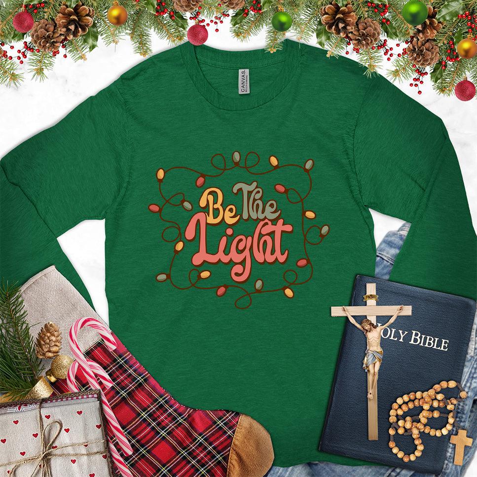 Be The Light Colored Edition Long Sleeves Kelly - Inspiring 'Be The Light' design on a long sleeve tee with cozy holiday vibes.