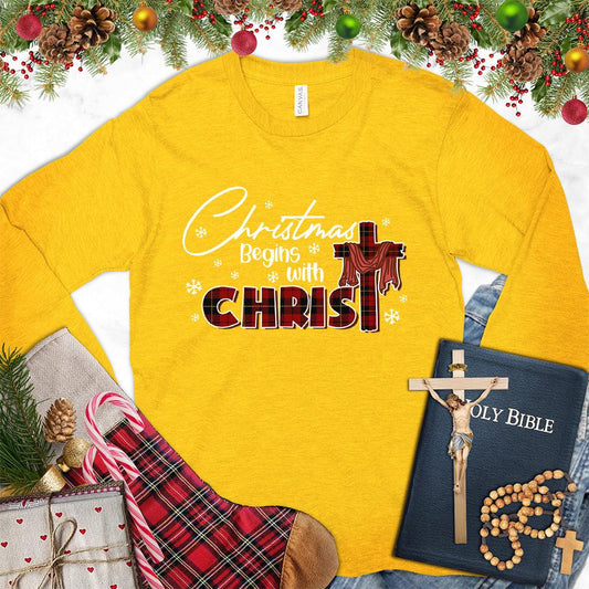 Christmas Begins With Christ Colored Edition Long Sleeves Gold - Long-sleeved holiday shirt with "Christmas Begins With Christ" design, festive and faith-inspired.