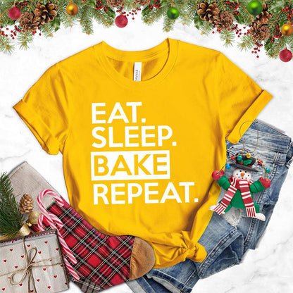 Eat Sleep Bake Repeat T-Shirt Gold - Illustration of fun 'Eat Sleep Bake Repeat' phrase on casual t-shirt for baking fans