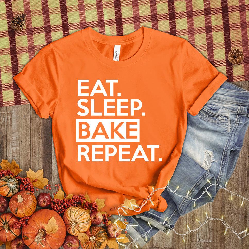 Eat Sleep Bake Repeat T-Shirt Orange - Illustration of fun 'Eat Sleep Bake Repeat' phrase on casual t-shirt for baking fans