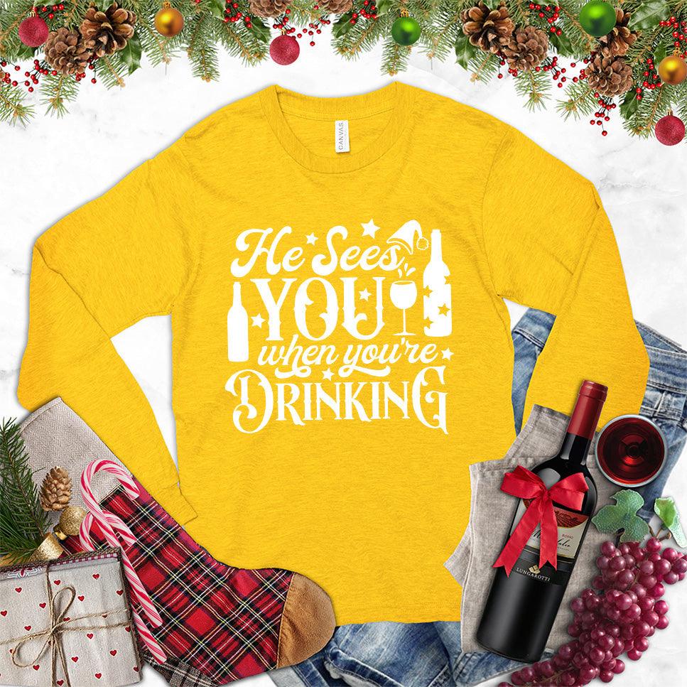 He Sees You When You're Drinking Long Sleeves Gold - Humorous long sleeve holiday shirt with festive drinking phrase design