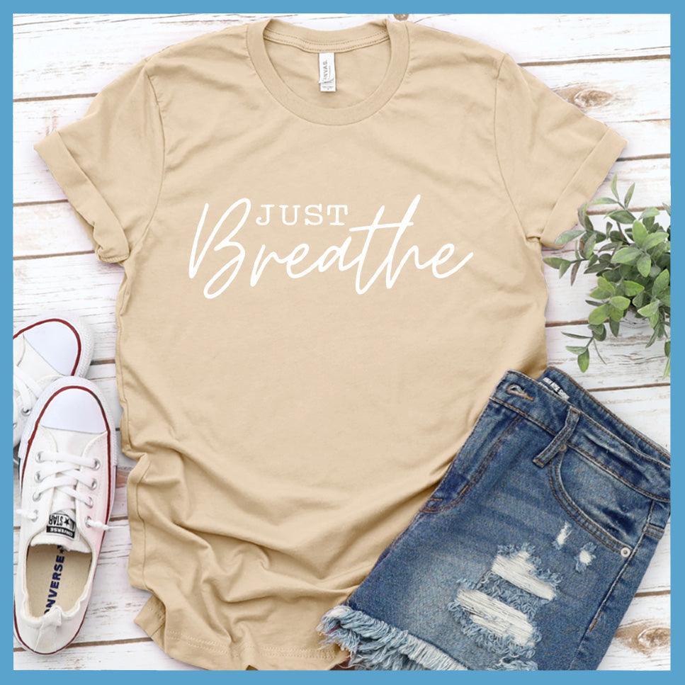 Just Breathe T-Shirt Soft Cream - Elegant Just Breathe script on a stylish, crew neck t-shirt for mindful expression.