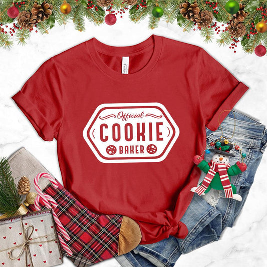 Official Cookie Baker T-Shirt Canvas Red - Graphic tee with 'Official Cookie Baker' logo in a festive kitchen setting