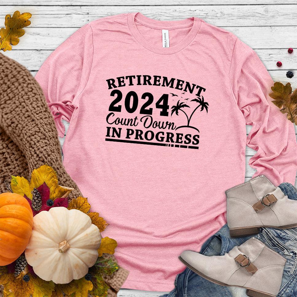 Retirement 2024 Countdown In Progress Long Sleeves Pink - "Retirement 2024 Countdown" graphic long sleeve t-shirt with fun beach design.
