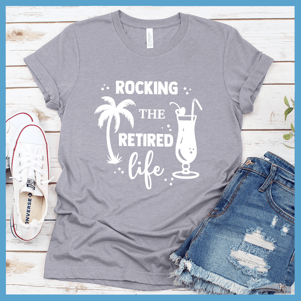 Rocking The Retired Life T-Shirt Heather Storm - Retirement-themed t-shirt with palm tree and drink design celebrating the leisure life.