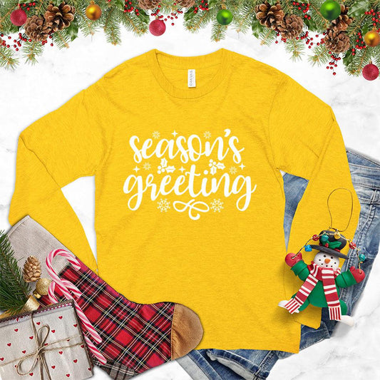 Season's Greeting Long Sleeves Gold - Cozy long sleeve tee with festive 'Season's Greeting' and snowflakes design, ideal for holiday celebrations.