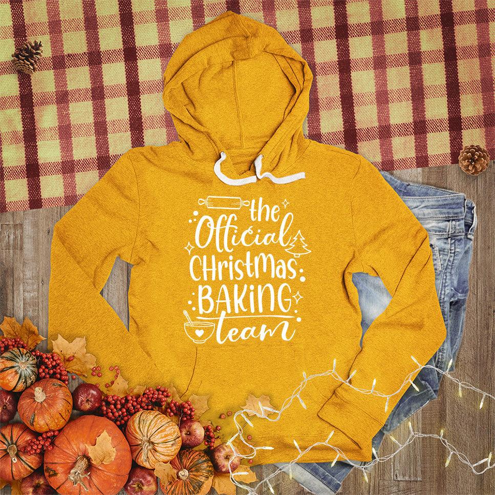 The Official Christmas Baking Team Hoodie Heather Mustard - Festive hoodie with Christmas baking theme design, perfect for holiday cooking.
