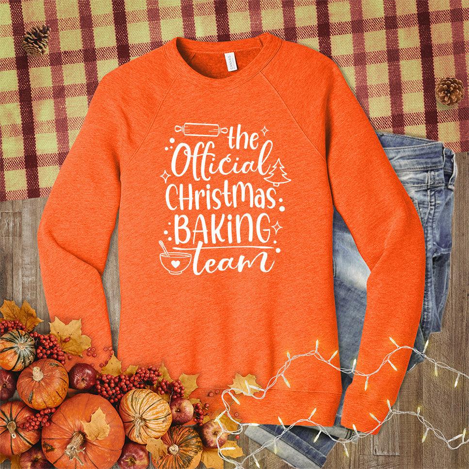 The Official Christmas Baking Team Sweatshirt Orange - Cozy holiday sweatshirt with Christmas Baking Team design, perfect for festive cooking activities.