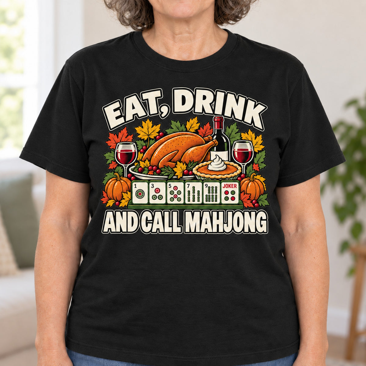 Eat, Drink And Call Mahjong T-shirt in Black, close-up of the print, worn by Linda. Linda is 5′5″ and wears her usual size L. [bb c=black r=close]