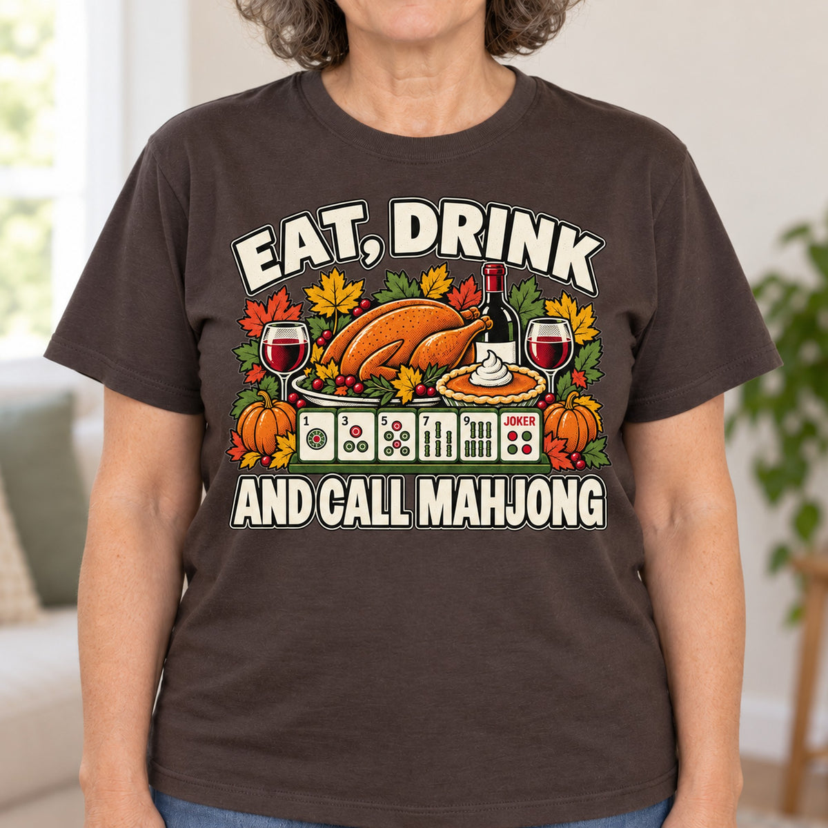 Eat, Drink And Call Mahjong T-shirt in Dark Chocolate, close-up of the print, worn by Linda. Linda is 5′5″ and wears her usual size L. [bb c=dark-chocolate r=close]