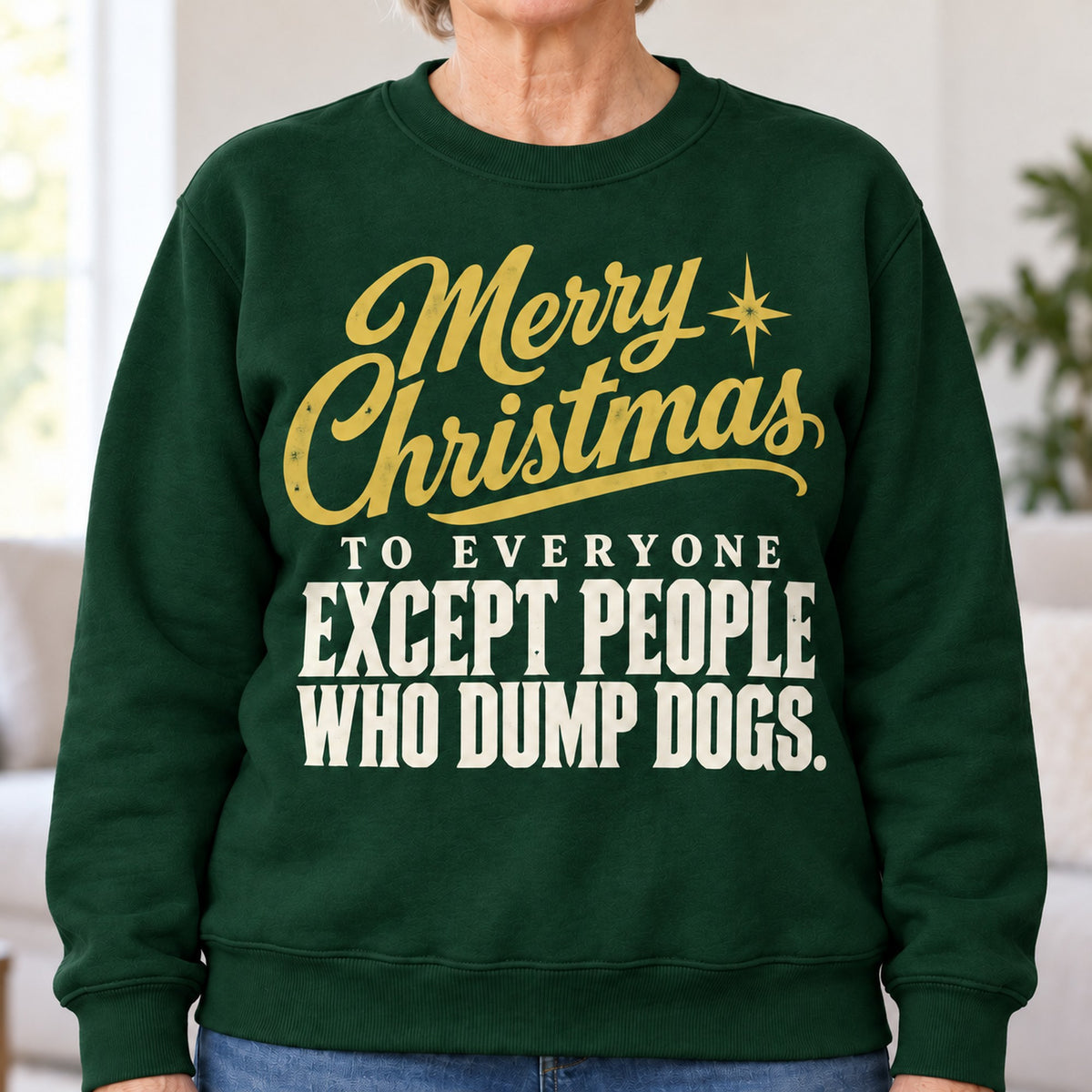 Merry Christmas Except People Who Dump Dogs sweatshirt in Forest Green, close-up of the print, worn by Nancy. Nancy is 5′5″ and wears her usual size L. [bb c=forest-green r=close]