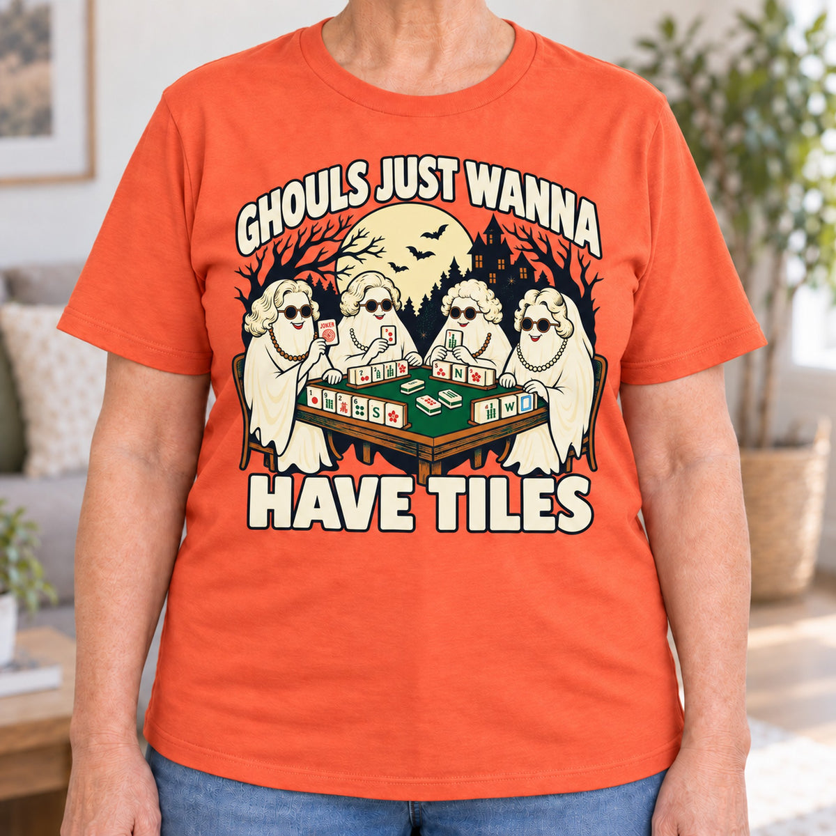 Ghouls Just Wanna Have Tiles mahjong T-shirt in Orange, close-up of the print, worn by Judy. Judy is 5′5″ and wears her usual size L. [bb c=orange r=close]