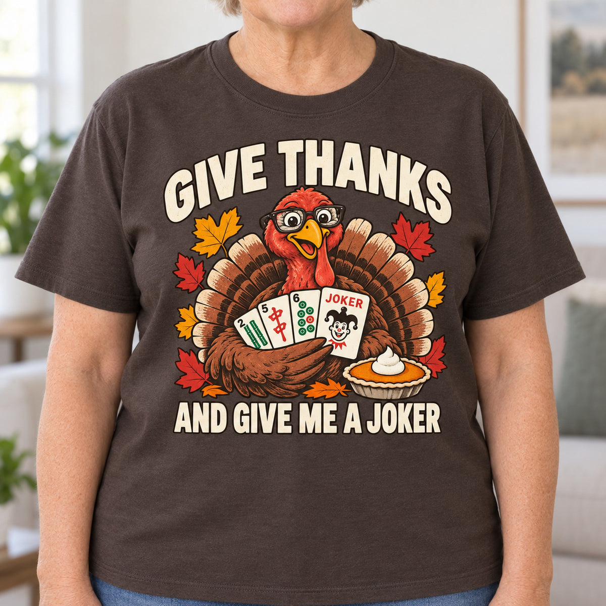 Give Thanks mahjong T-shirt in Dark Chocolate, close-up of the print, worn by Barbara. Barbara is 5′5″ and wears her usual size L. [bb c=dark-chocolate r=close]