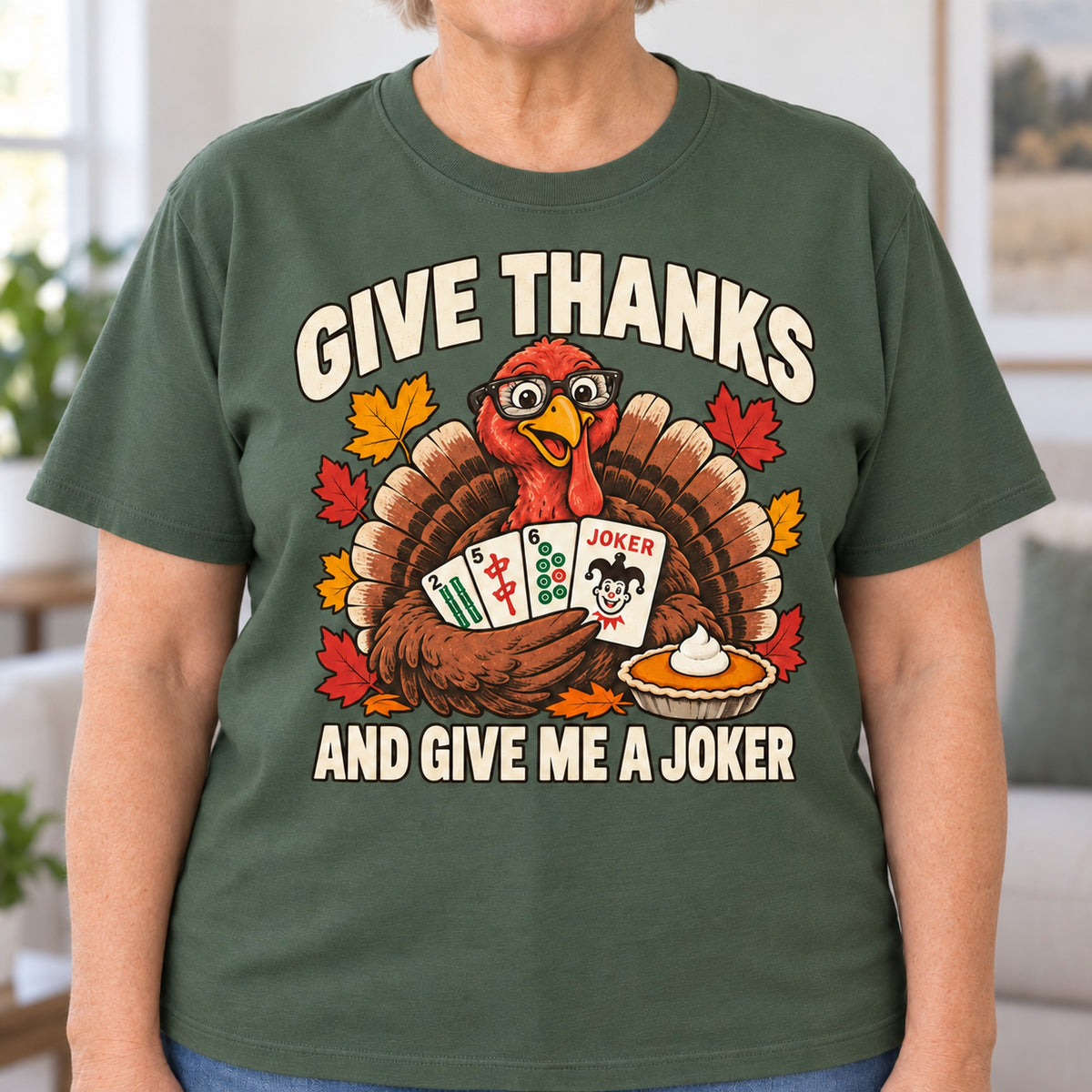 Give Thanks mahjong T-shirt in Military Green, close-up of the print, worn by Barbara. Barbara is 5′5″ and wears her usual size L. [bb c=military-green r=close]