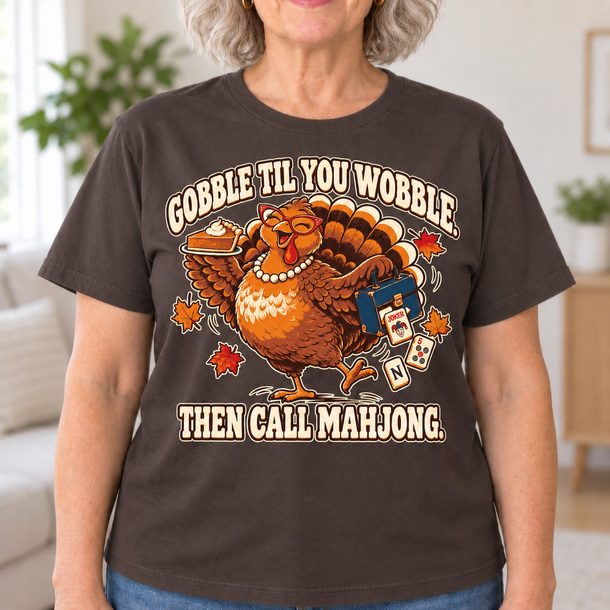 Gobble Til You Wobble mahjong T-shirt in Dark Chocolate, close-up of the print, worn by Donna. Donna is 5′5″ and wears her usual size L. [bb c=dark-chocolate r=close]