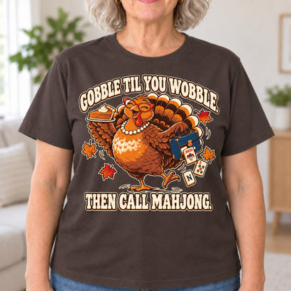 Gobble Til You Wobble mahjong T-shirt in Dark Chocolate, close-up of the print, worn by Donna. Donna is 5′5″ and wears her usual size L. [bb c=dark-chocolate r=close]
