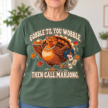 Gobble Til You Wobble mahjong T-shirt in Military Green, close-up of the print, worn by Donna. Donna is 5′5″ and wears her usual size L. [bb c=military-green r=close]