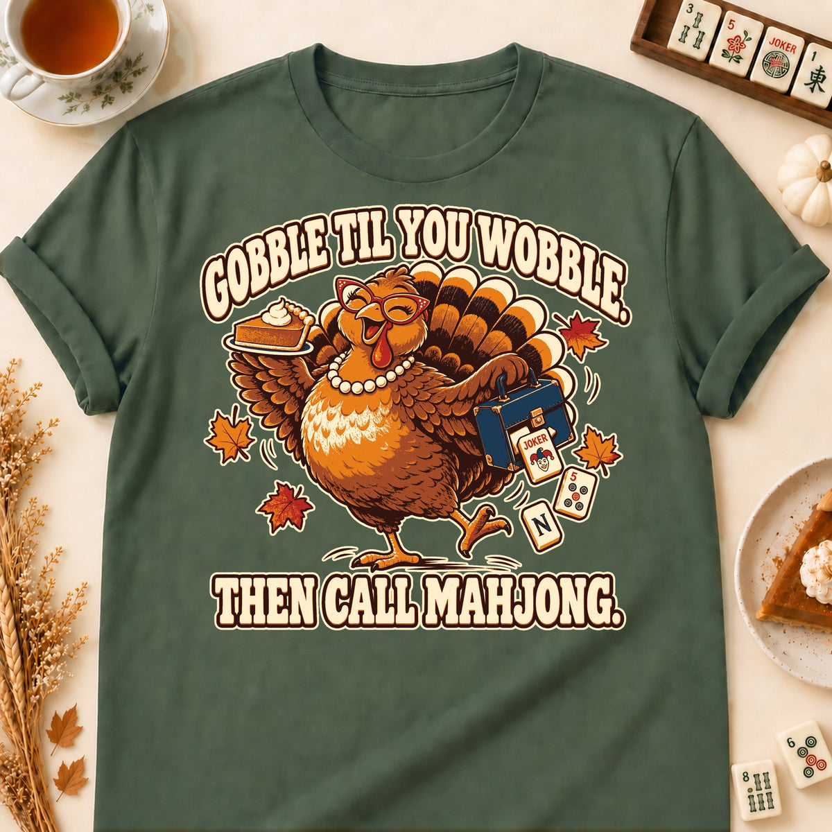 Gobble Til You Wobble mahjong T-shirt in Military Green, laid flat. [bb c=military-green r=flat]