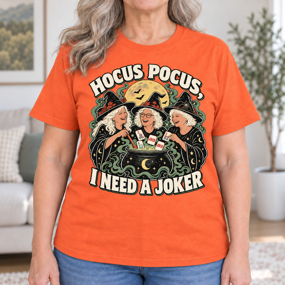Hocus Pocus mahjong T-shirt in Orange, close-up of the print, worn by Sandra. Sandra is 5′5″ and wears her usual size L. [bb c=orange r=close]