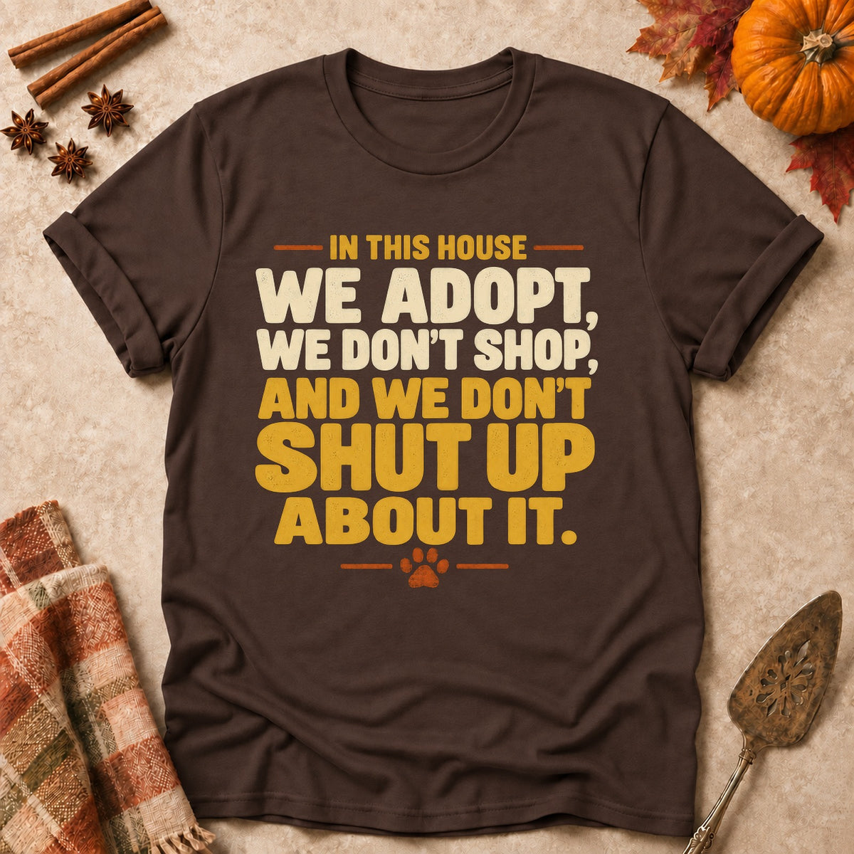 We Don't Shut Up About It dog mom T-shirt in Dark Chocolate, laid flat. [bb c=dark-chocolate r=flat]