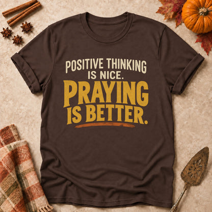 Praying Is Better faith T-shirt in Dark Chocolate, laid flat. [bb c=dark-chocolate r=flat]