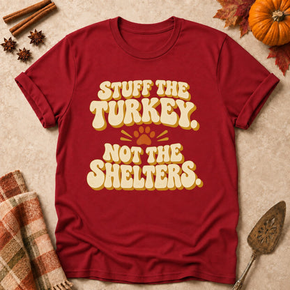 Stuff The Turkey, Not The Shelters dog mom T-shirt in Cardinal Red, laid flat. [bb c=cardinal-red r=flat]