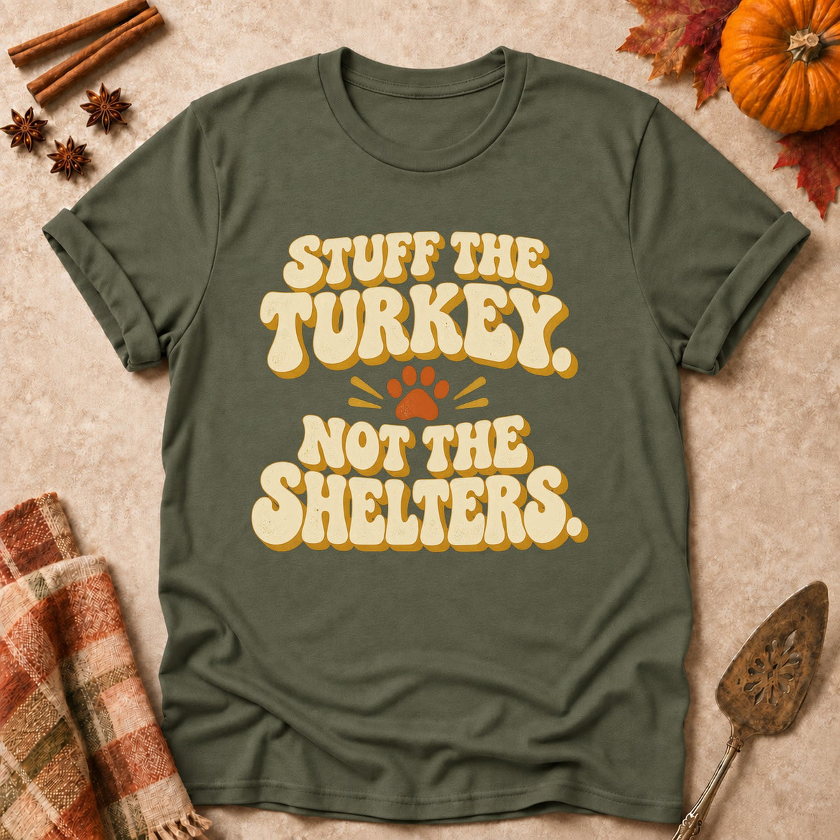 Stuff The Turkey, Not The Shelters dog mom T-shirt in Military Green, laid flat. [bb c=military-green r=flat]