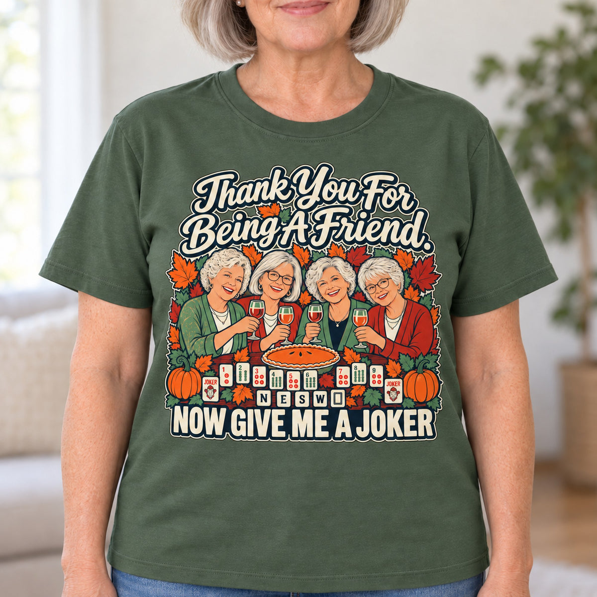 Thank You For Being A Friend mahjong T-shirt in Military Green, close-up of the print, worn by Lorraine. Lorraine is 5′5″ and wears her usual size L. [bb c=military-green r=close]