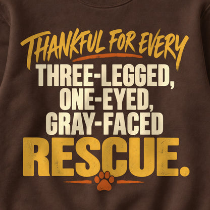 Thankful For Every Three-Legged, One-Eyed, Gray-Faced Rescue. Colored Print Sweatshirt in Dark Chocolate — design detail