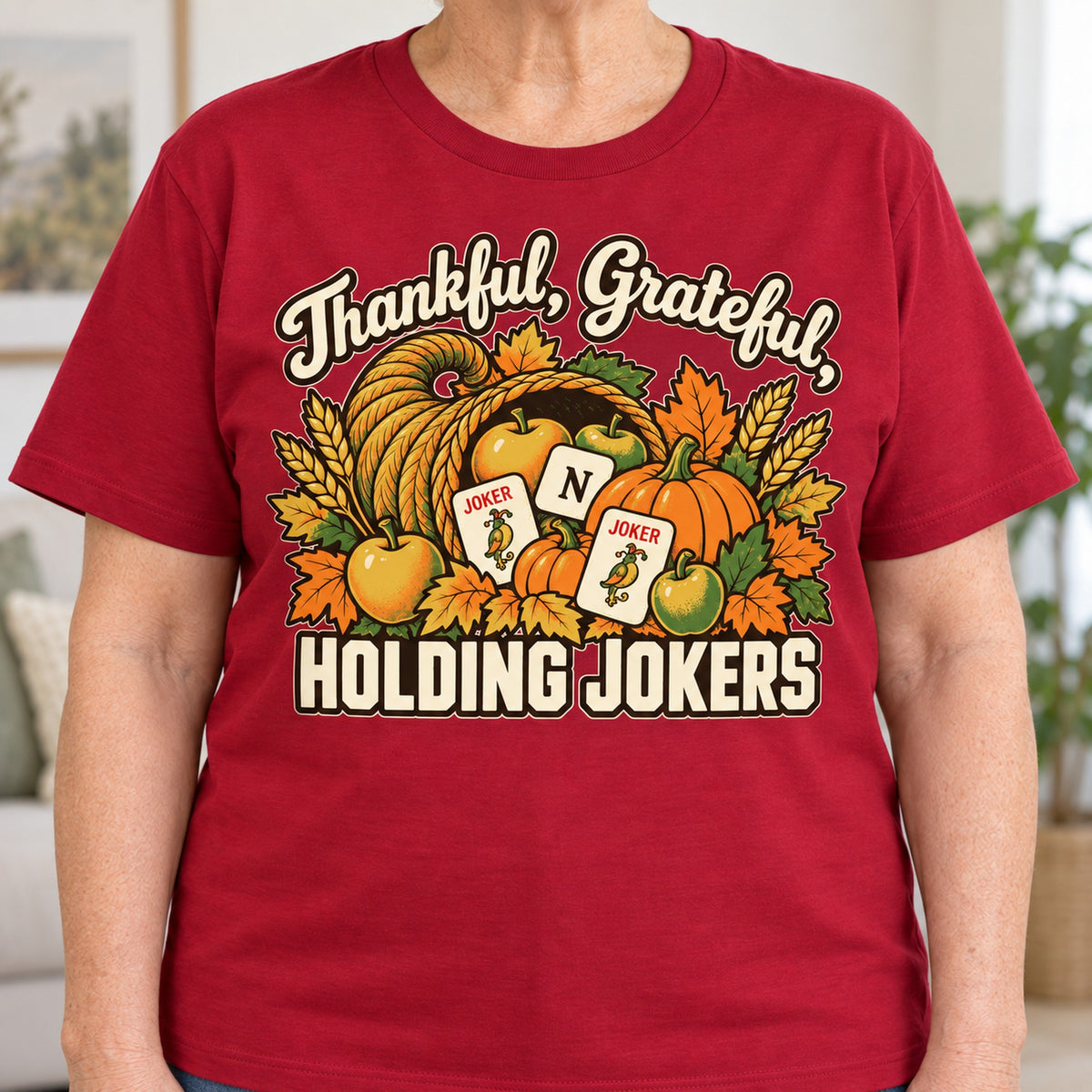Thankful, Grateful, Holding Jokers mahjong T-shirt in Cardinal Red, close-up of the print, worn by Barbara. Barbara is 5′5″ and wears her usual size L. [bb c=cardinal-red r=close]