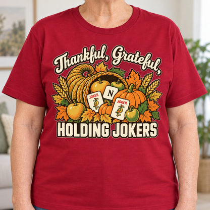 Thankful, Grateful, Holding Jokers mahjong T-shirt in Cardinal Red, close-up of the print, worn by Barbara. Barbara is 5′5″ and wears her usual size L. [bb c=cardinal-red r=close]