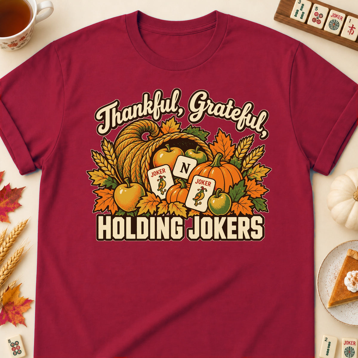 Thankful, Grateful, Holding Jokers mahjong T-shirt in Cardinal Red, laid flat. [bb c=cardinal-red r=flat]