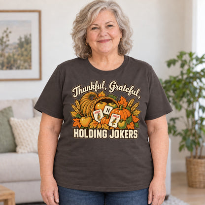 Thankful, Grateful, Holding Jokers mahjong T-shirt in Dark Chocolate, worn by Debra. Debra is 5′4″ and wears her usual size 2XL. [bb c=dark-chocolate r=body2]
