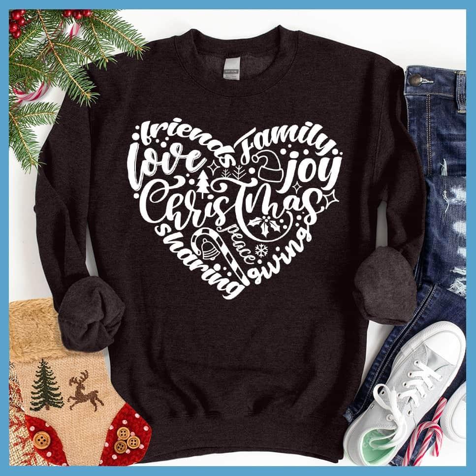 Christmas Heart Sweatshirt Black - Holiday-themed graphic sweatshirt with Christmas and joyful expressions in heart design.