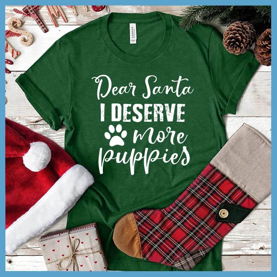 Dear Santa I Deserve More Puppies T-Shirt Heather Grass Green - Humorous holiday-themed T-shirt with 'Dear Santa I Deserve More Puppies' message in festive script.