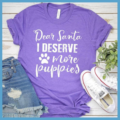 Dear Santa I Deserve More Puppies T-Shirt Heather Purple - Humorous holiday-themed T-shirt with 'Dear Santa I Deserve More Puppies' message in festive script.