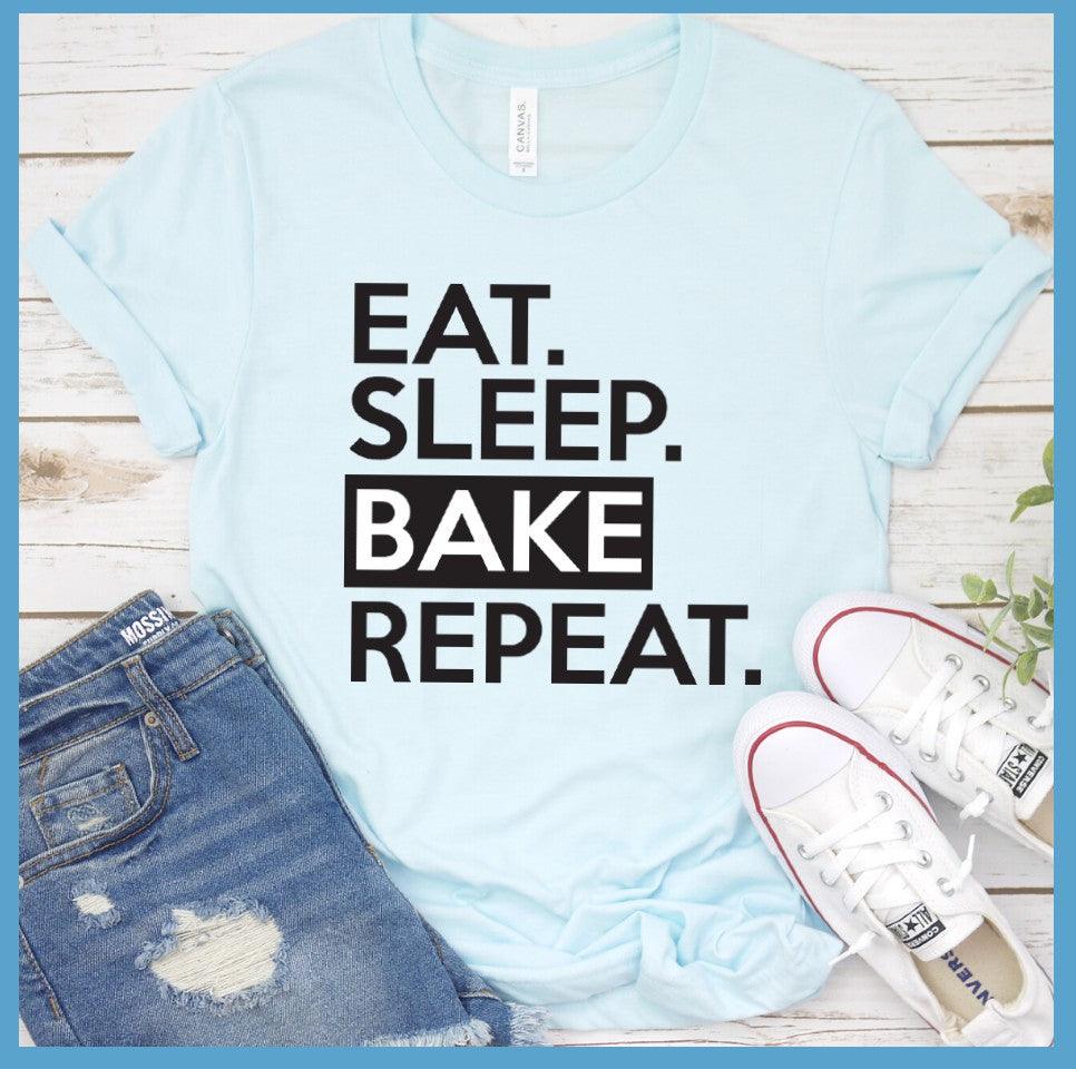 Eat Sleep Bake Repeat T-Shirt Heather Ice Blue - Illustration of fun 'Eat Sleep Bake Repeat' phrase on casual t-shirt for baking fans