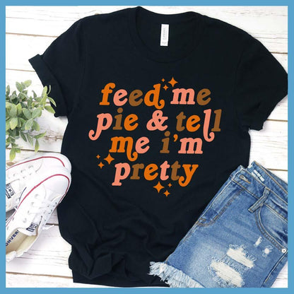 Feed Me Pie & Tell Me I’m Pretty Colored T-Shirt Black - Graphic t-shirt with "Feed Me Pie & Tell Me I’m Pretty" text, perfect for casual chic styling.