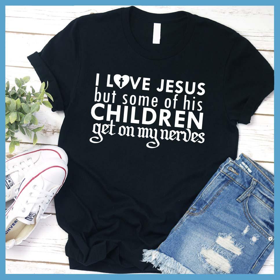 I Love Jesus But Some Of His Children T-Shirt Black - Humorous 'I Love Jesus But Some Of His Children' faith-based T-shirt laid out with jeans and sneakers.