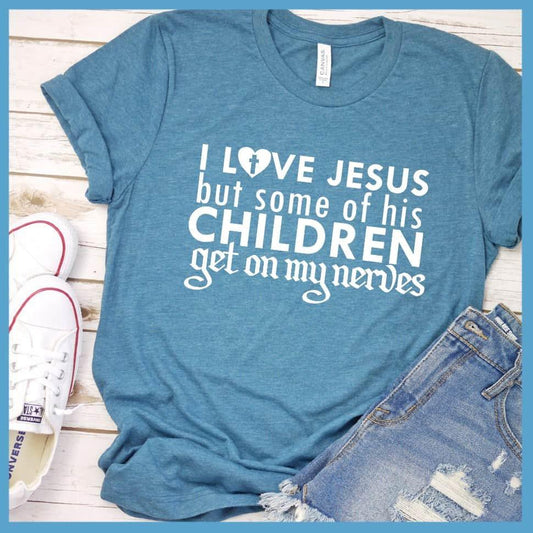 I Love Jesus But Some Of His Children T-Shirt Heather Deep Teal - Humorous 'I Love Jesus But Some Of His Children' faith-based T-shirt laid out with jeans and sneakers.