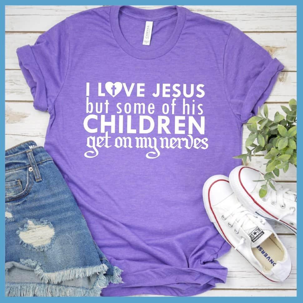 I Love Jesus But Some Of His Children T-Shirt Heather Purple - Humorous 'I Love Jesus But Some Of His Children' faith-based T-shirt laid out with jeans and sneakers.
