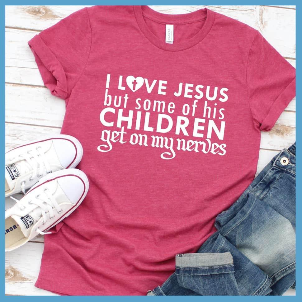 I Love Jesus But Some Of His Children T-Shirt Heather Raspberry - Humorous 'I Love Jesus But Some Of His Children' faith-based T-shirt laid out with jeans and sneakers.