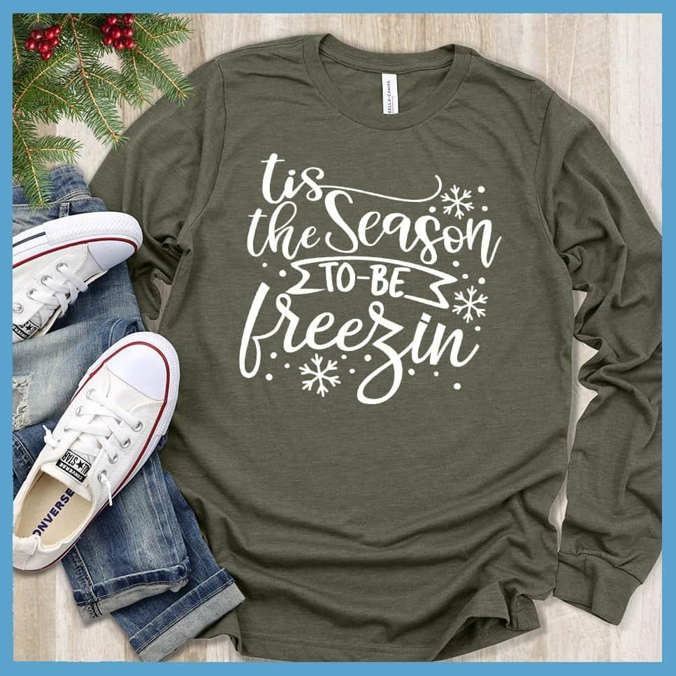 Tis The Season To Be Freezin Long Sleeves Military Green - Long sleeve winter shirt with whimsical snowflake design and festive phrase.