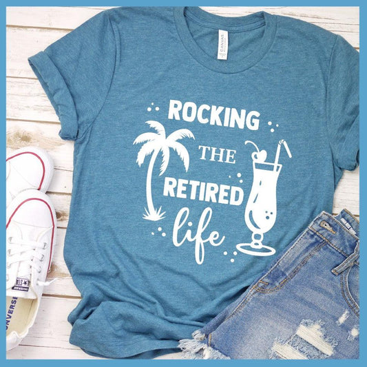 Rocking The Retired Life T-Shirt Heather Deep Teal - Retirement-themed t-shirt with palm tree and drink design celebrating the leisure life.